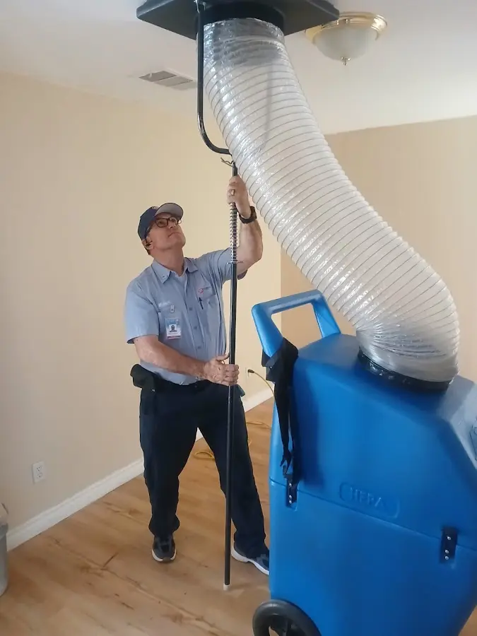 Furnace Tune-Up technician using HEPA equipment in Salida